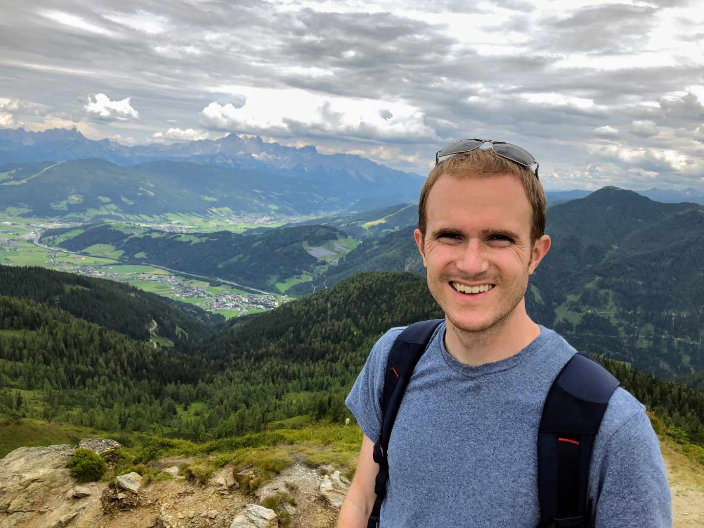 Brad on an Austrian alp mountain wearing a backpack 